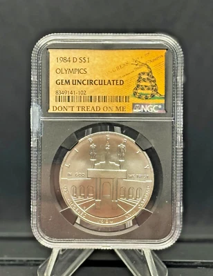 1984-D Olympic $1 🇺🇸 NGC GEM UNC 🐍 DTOM Label – Patriotic Silver Dollar 💎 - Image 1 of 4