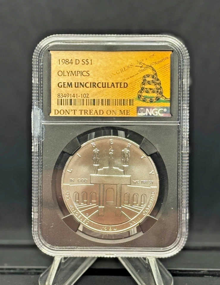 1984-D Olympic $1 🇺🇸 NGC GEM UNC 🐍 DTOM Label – Patriotic Silver Dollar 💎 - Image 1 of 4
