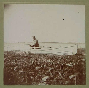 c1915 Photograph Hunter with Rifle in Boat at Lake Edge - Picture 1 of 1