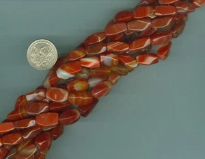 16 Inch strand of Natural Carnelian Beads Twisted Barrel Beads 7mm x 17mm - Picture 1 of 1