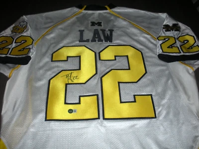 ¡Wolverines de MICHIGAN TY LAW! CAMISETA ADIDAS FIRMADA POR BECKETT/COA con licencia oficial Foto 1 de 2