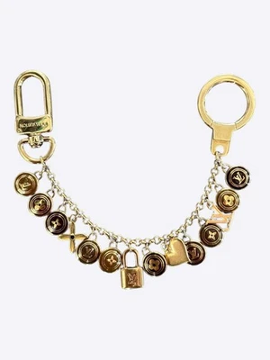 Berloque bolsa chaveiro Louis Vuitton ouro e marrom pestilhas - Imagem 1 de 3