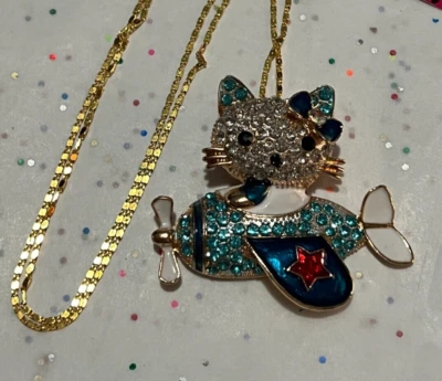 Collar/alfiler avión gatito tono dorado con cristales azules Foto 1 de 4