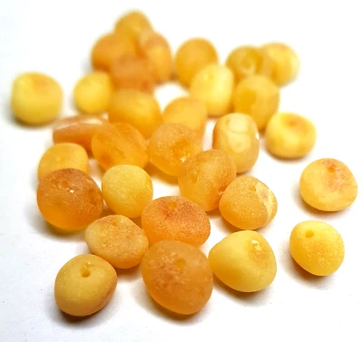 REAL RAW BALTIC AMBER , HOLED ROUND 30 BEADS ( 0,15 - 0,23 inches ), egg yolk - Image 1 of 4