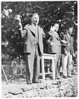 Auctioneer John W Mitchell, holding beer stein , mouth open and ar- Old Photo