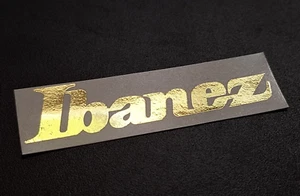 Confezione 2 Decalcomanie Ibanez Headstock Waterslide Oro Massiccio 66mm per Chitarre NUOVE - Foto 1 di 1