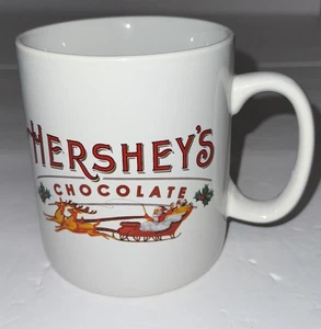 Tazza da caffè natalizia al cioccolato Hershey's | 32 once  Tazza bianca | Babbo Natale e slitta - Foto 1 di 1