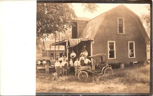 THIRTEEN PEOPLE ON FRONT PORCH OF HOUSE :AMERICAN FLAG :OLD CAR : RPPC 1904-1918 - Picture 1 of 4