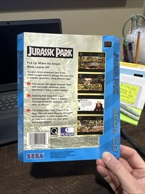 Arte de contraportada de CD Sega solo Jurassic Park da&ntilde;os por agua