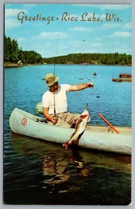 Postcard Rice Lake WI c1963 Greetings From Rice Lake Man Fishing In Canoe - Picture 1 of 2