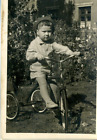 USSR Vintage Art photo boy on a Soviet retro toy pedal bike three wheels