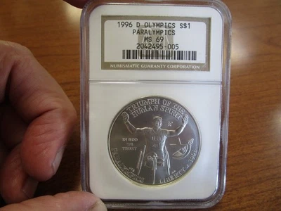 United States Commemorative Silver Dollar 1996-D Paralympic Wheelchair NGC MS69 - Image 1 of 2