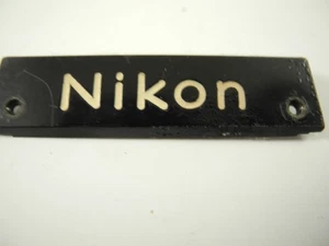 NIKON F BLACK PAINT FRONT NAME PLATE NICE WITH SCREWS TAPED ON BACK - Picture 1 of 4