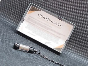 Genuine meteorite fragment/dust with holographic effect in black pendant COA - Picture 1 of 7