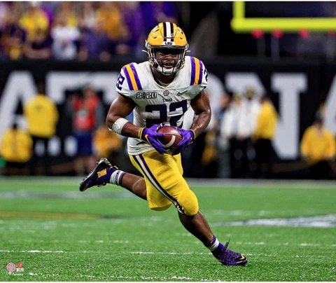 Clyde Edwards-Helaire LSU Tigers Unsigned White Jersey Running Photograph Cover