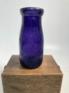 Milk bottle, round HALF PINT, COOK BROS., from Brooklyn, purple, irradiated, - Picture 1 of 5