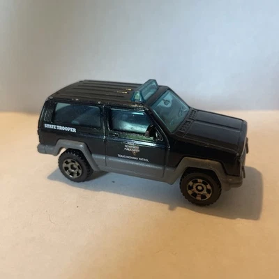 2018 Matchbox Texas Patrol Jeep Cherokee XJ Black State Trooper Police 1:64 NM - Image 1 of 4