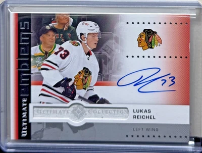 2024-25 Upper Deck Ultimate Lukas Reichel Emblems Auto - Image 1 of 2