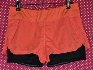 Pantaloncini corti donna Athleta 2 in 1 pulse running ciclismo arancione taglia media  - Foto 1 di 4
