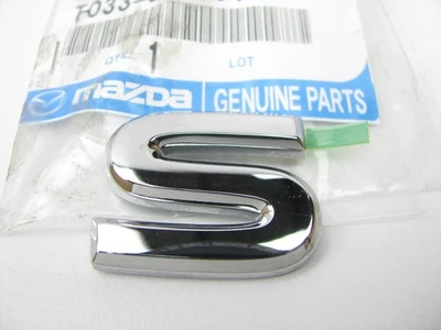 NEW - OEM T03351761 REAR S Emblem Nameplate Badge For 1999-2002 Mazda Millenia - Image 1 of 3
