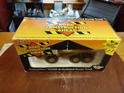 Camión de volteo articulado vintage ERTL escala 1:50 Caterpillar D350D en caja Foto 1 de 4