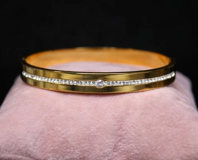 Gold Tone Stainless Steel Hinged Bangle Bracelet with Cubic Zirconia Accents - Image 1 of 4