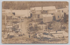 Postcard RPPC Aerial View of Small Town Construction Site Lumber People Dog - Imagen 1 de 10