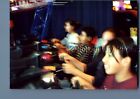 FOUND COLOR PHOTO O+8457 BLURRED KIDS SITTING PLAYING VIDEO GAME