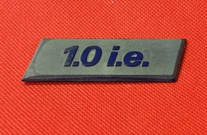 FIAT UNO FIRE 1.0 i.e. - VINTAGE PLASTIC CAR BADGE / EMBLEM - 75 X 25 MM - Picture 1 of 2