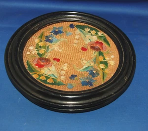 An unusual ebonised trivet or coaster, floral hand embroidery, small wheels, 19C - Picture 1 of 3