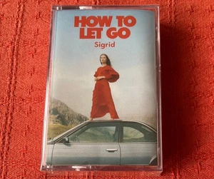 SIGRID - UK CASSETTE TAPE - HOW TO LET GO - BRAND NEW & SEALED - RED SHELL - Picture 1 of 3