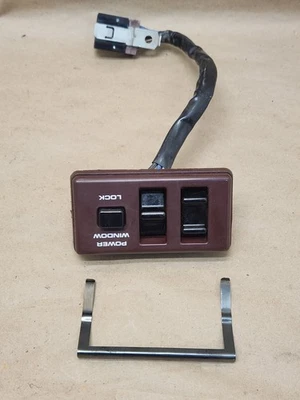 Interruptor de ventana maestra izquierda Nissan Pathfinder D21 1986-1989 Borgoña OEM Foto 1 de 4