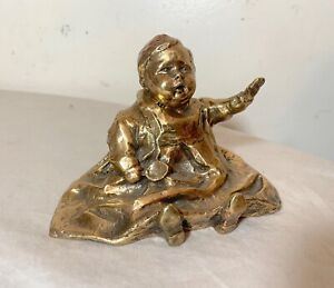 antique polished signed bronze statue of a baby with spoon sculpture figure