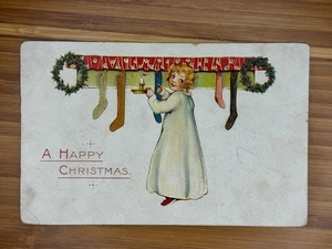 Antike AK Ein frohes Weihnachtsmädchen mit Kerze und Strümpfen 1917 - Bild 1 von 2