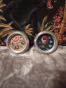 Three metal with floral cross stitch under glass in middle coasters. - Picture 1 of 5