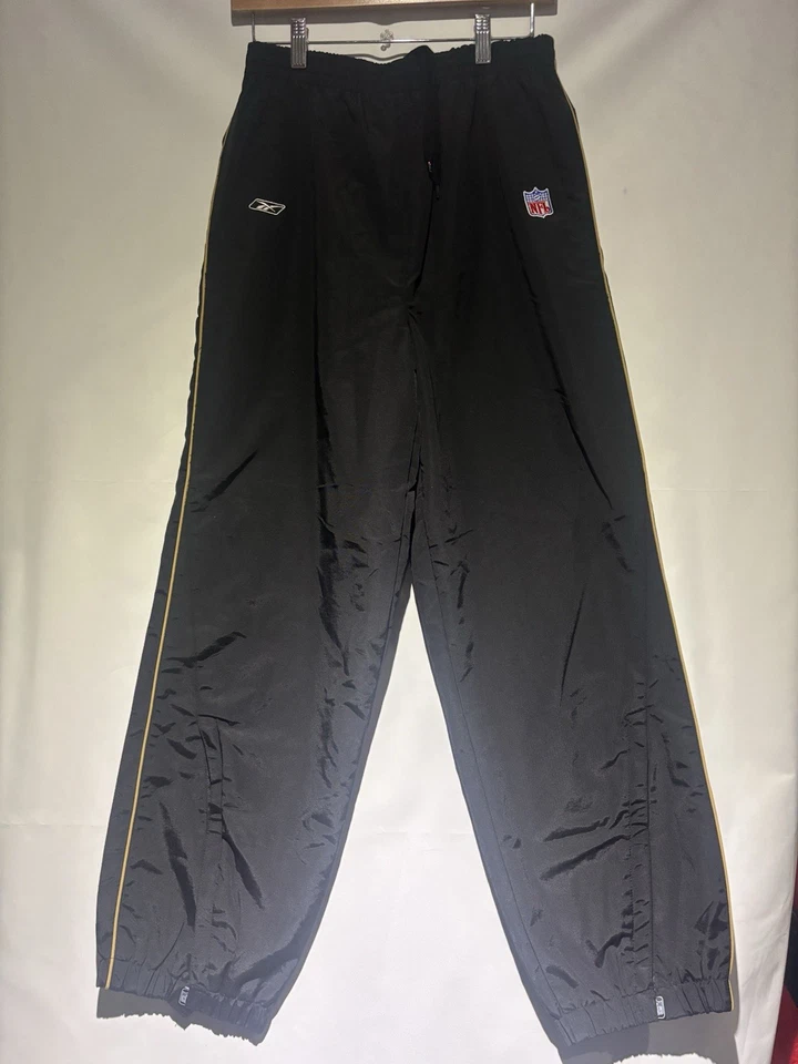 Pantalones cortavientos Reebok negros 49ers NFL talla L Foto 1 de 4