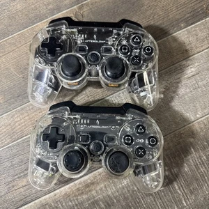 2 Afterglow PS3 Clear Controller - PDP 064-015T - funktionstüchtig, einer fehlt Rückseite - Bild 1 von 6