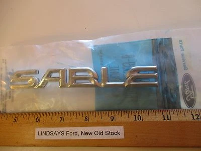 Parachoques trasero Ford 1996/1997 Mercury Sable emblema/insignia "placa de nombre" SIN ABRIR NOS Foto 1 de 3