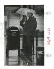 1990 Press Photo Donna Sanner Waits in Rain For Bus in Houston. - hca12400