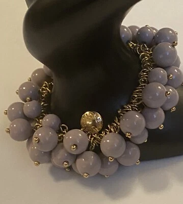 Brazalete elástico estilo cha cha cha tono dorado con cuentas chuchería púrpura firmada por J CREW Foto 1 de 4
