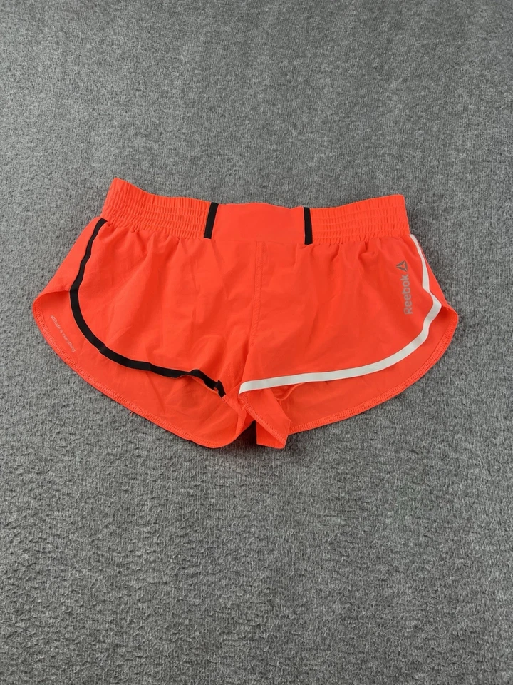 Pantalones cortos para mujer Reebok forrados en naranja talla pequeña de 2" Foto 1 de 4