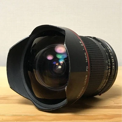 Nuevo lente gran angular ojo de pez Canon FD NFD 14 mm F2,8 L negro con tapas traseras delanteras Foto 1 de 4