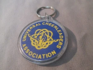 UNIVERSAL CHEERLEADERS ASSOCIATION PLASTIC KEYCHAIN BACKPACK CHARM - Picture 1 of 1