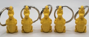 Vintage Tupperware Douglas Dirtwalker Dragon Dinosaur Keychains Yellow Set of 5 - Picture 1 of 6