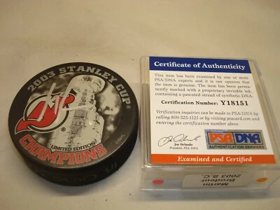 Martin Brodeur Signed 2003 Stanley Cup Champs Hockey Puck Auto. PSA/DNA COA 1A - Image 1 of 4