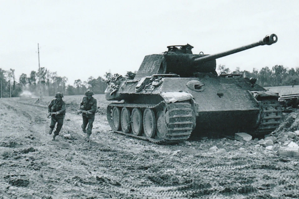 WW II  Canada  Photo -- Soldier Pass A Knock Out Panther Tank - Image 1 of 1