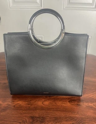 Bolso Bandolera BCBGeneration Negro Cartera Plata Anillo Mango - Usado En muy buen estado Foto 1 de 4