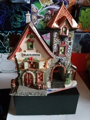 Edificio herrero coleccionable pueblo navideño Holiday Time Foto 1 de 4