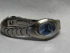 womens oakley watch with gold blade and blue quartz background and silver band - Picture 1 of 4