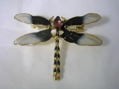 PIN LIBÉLULA CON ESMALTE BLANCO Y NEGRO EN ACERO INOXIDABLE TONO DORADO Foto 1 de 4